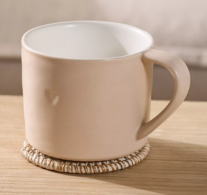 a pink porcelain mug with heart indent detail