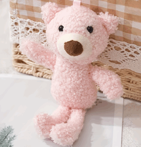 A pale pink teddy with small black eyes and a large brown nose.