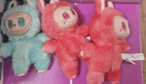 An image of three Big Into Energy dolls: one in blue and two in pink.