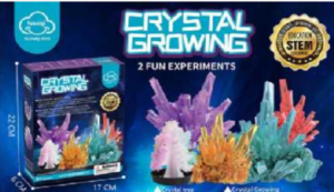Crystal growing kit with colourful crystal examples on the box and various tools and materials laid out, including containers, powders, and instructions