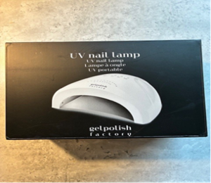 Box of a UV nail lamp showing an image of the white lamp 