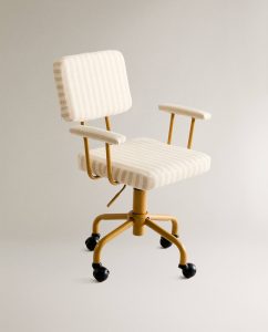 An image of a child's desk chair in yellow and white stripes, with side arms and four wheels.