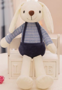 A rabbit plush toy wearing overalls