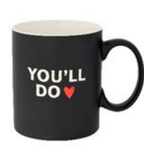 A black mug that says "you'll do" in white writing with a red heart beside it