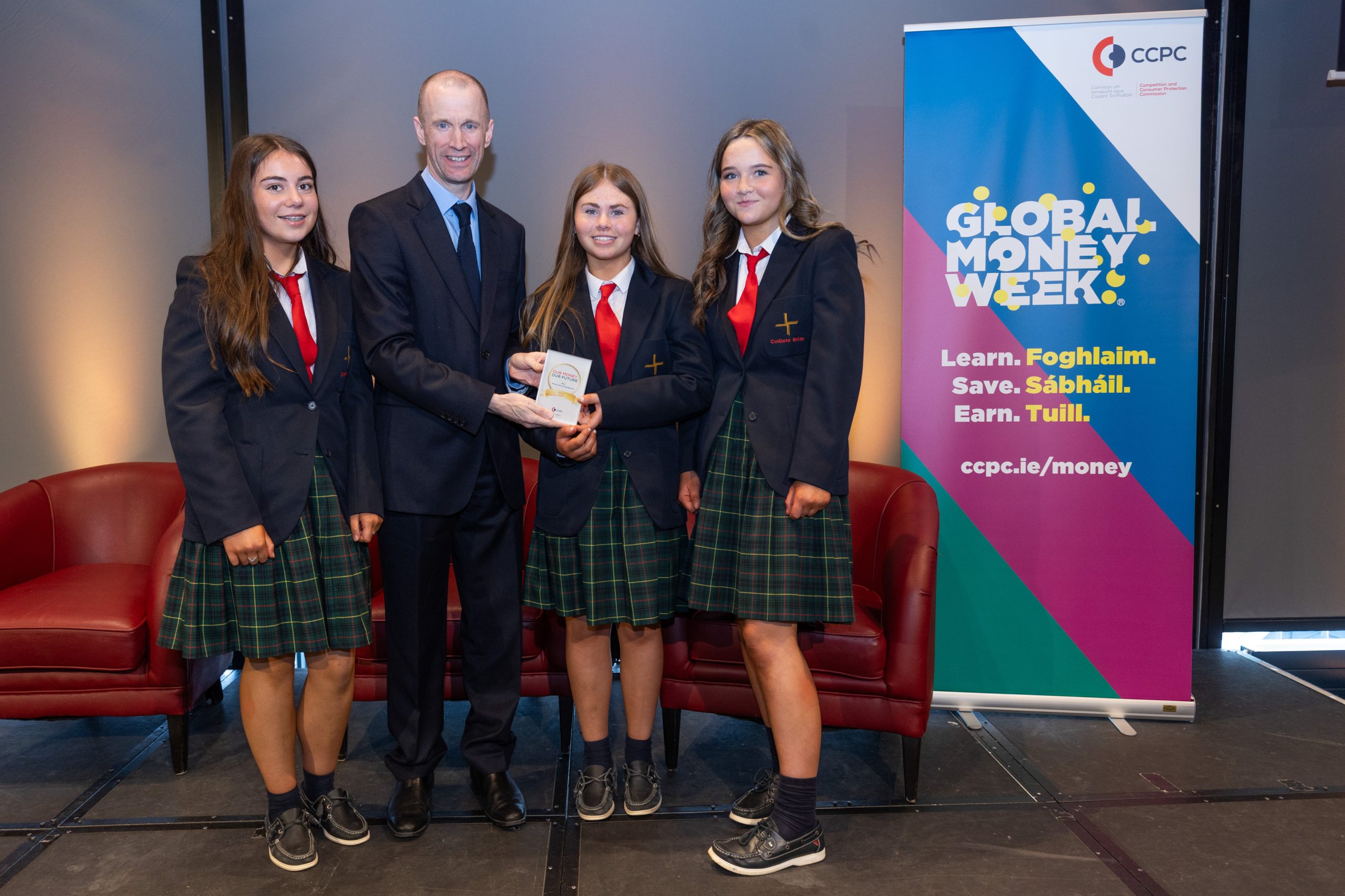 CCPC Chairperson Brian McHugh presenting students from Coláiste Bríde with their Our Money, Our Future award