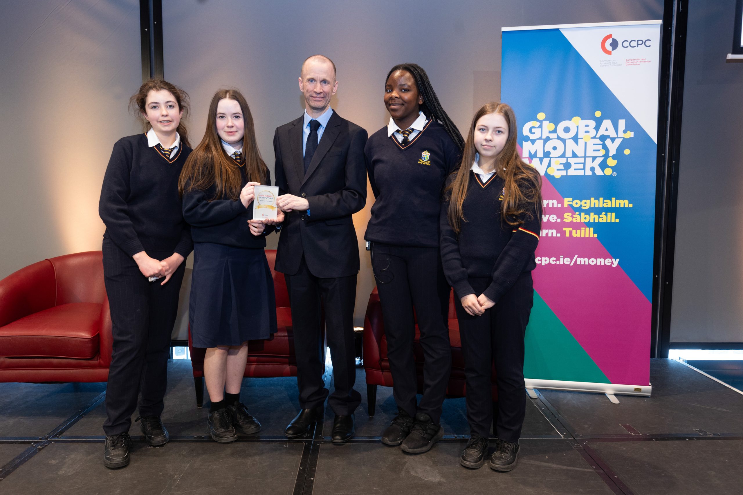 CCPC Chairperson Brian McHugh presenting students from St Mary's Secondary school with their Our Money, Our Future award