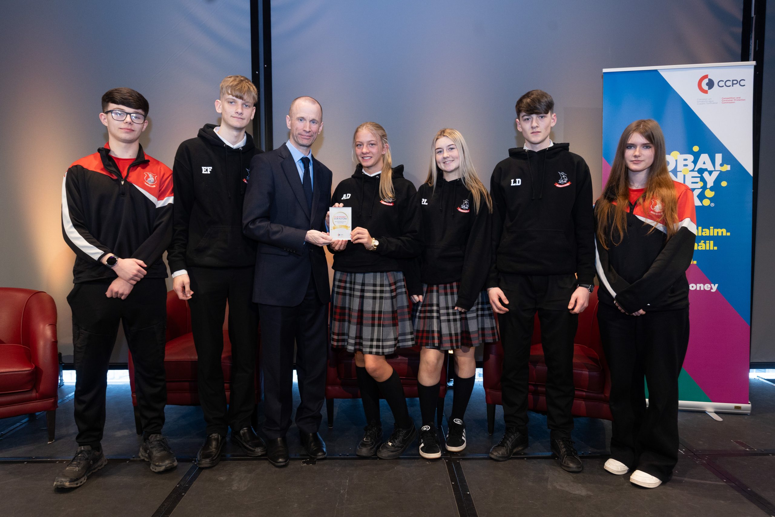 CCPC Chairperson Brian McHugh presenting students from Woodbrook College with their Our Money, Our Future award