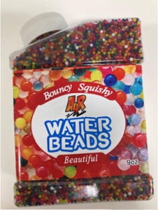 A plastic container filled with many small, colorful water beads. The label on the front reads ‘Bouncy Squishy Water Beads’ with the words arranged around a white center area, surrounded by images of multicolored beads. The container holds 9 ounces and has a white screw-on cap.