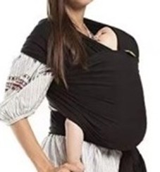 Image shows a baby being carried in a black sling which is held by being wrapped around a person's shoulder